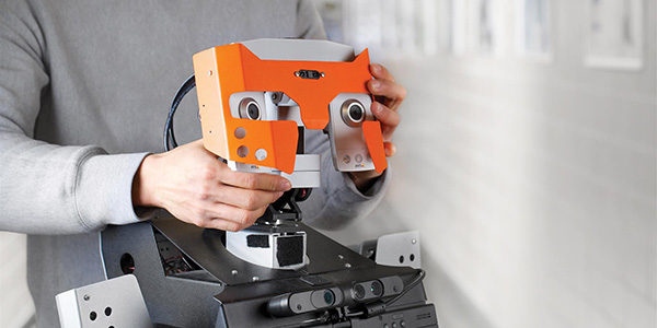 Tangy, a socially assistive robot with a distinctive ORANGE face, is designed to facilitate recreational activities and promote social interaction among people with degenerative cognitive conditions, such as dementia.