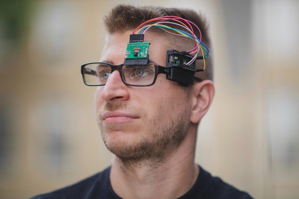 Brokoslaw Lachowski wearing a prototype of an AI-powered smart glasses he developed.
