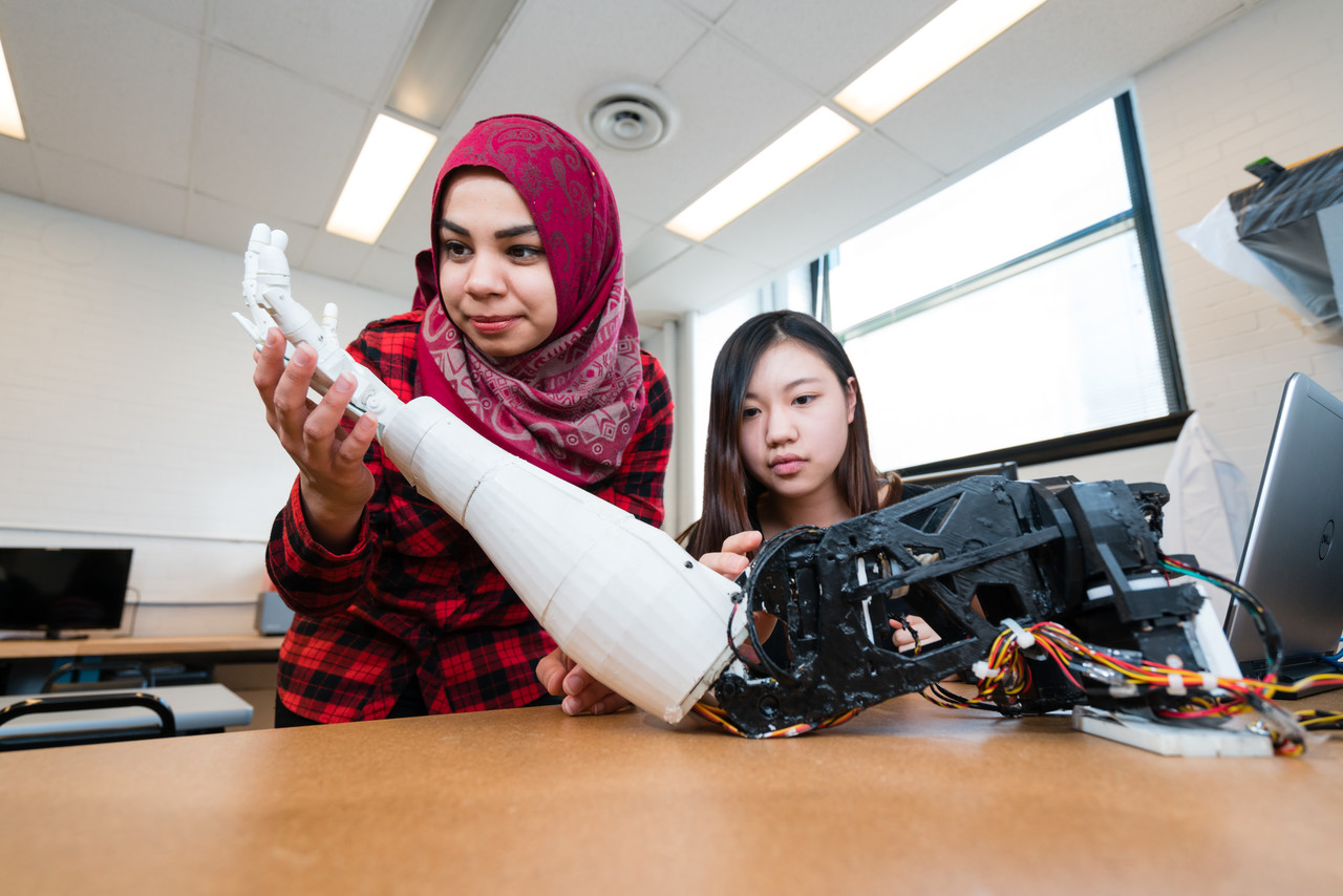 Students pose with robotics