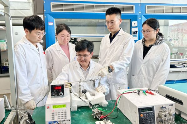 Huazhong University of Science and Technology researchers working in a lab with wearing personal protective equipment.
