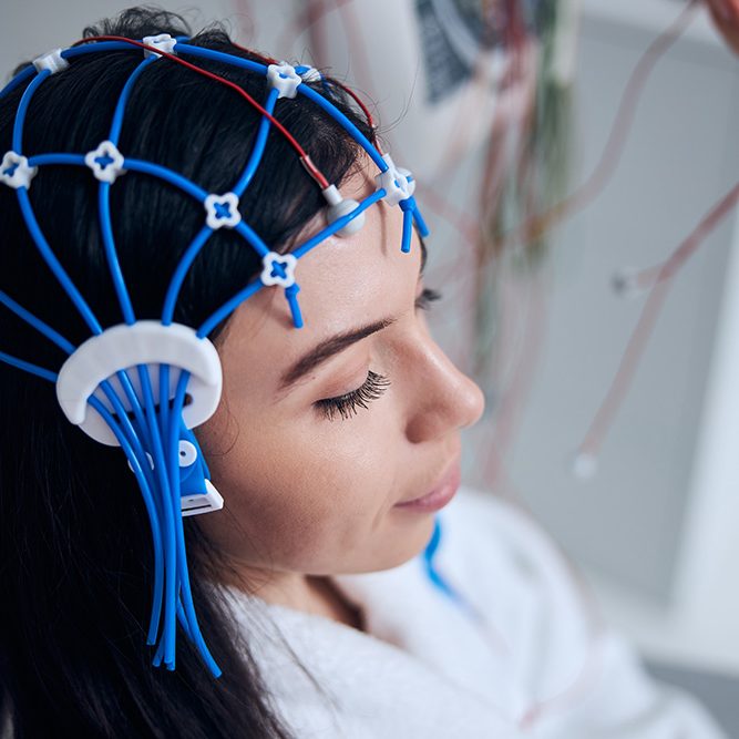 Woman with electroencephalography (EEG) gear on her head