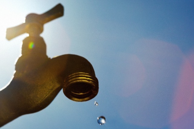 Small drops of water from a faucet