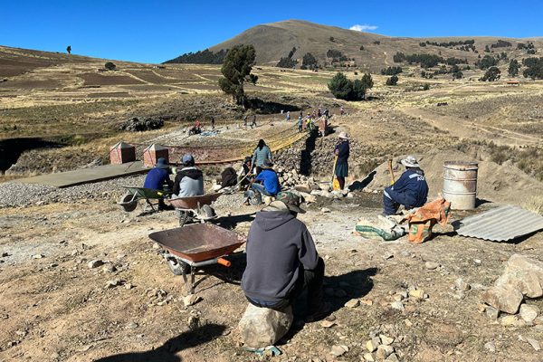 Bridge building crew in Suraj Mayu sitting and resting on site.